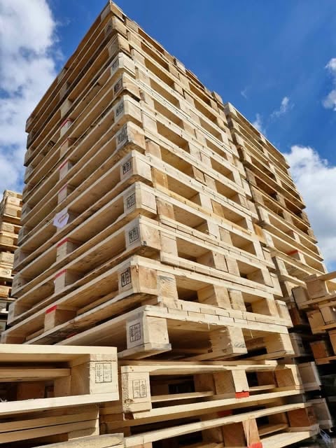 Multi-story concrete residential building under construction with exposed framework against a blue sky